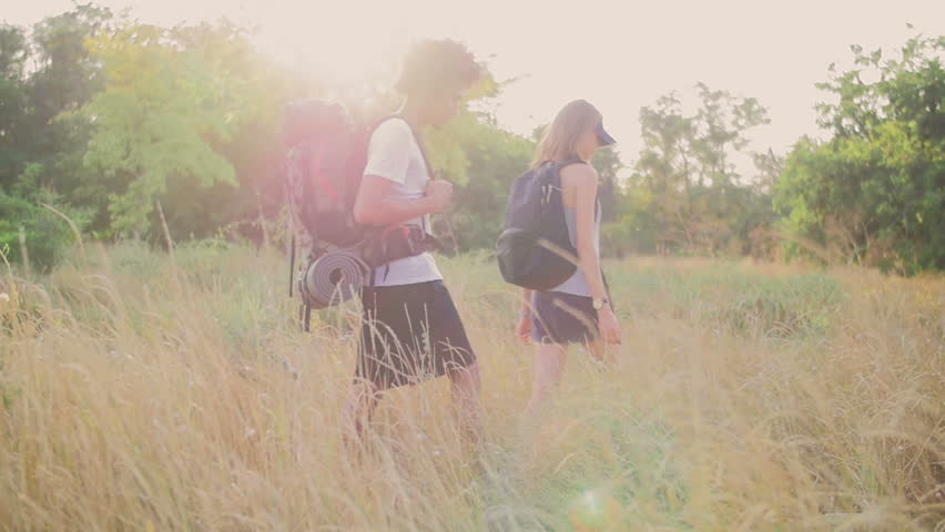 Young people went hiking in the wood. The guy and the girl already walk long enough and look for a place for a stop.
