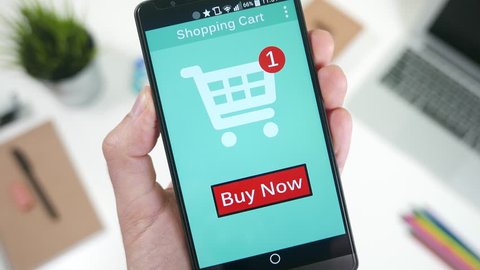 Pressing the Buy Now button to shop and pay a online store on smarrtphone.