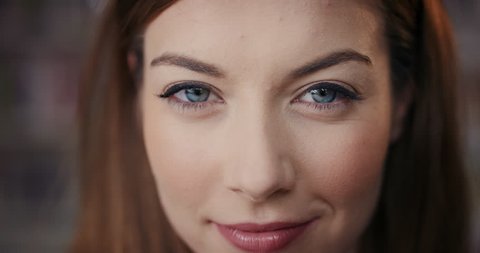 Dramatic Close up of beautiful brunette woman happy portrait happy smiling slow motion soft natural light on face center crop