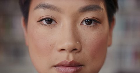 Dramatic Close up of beautiful Asian woman serious portrait slow motion soft natural light on face center crop