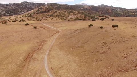 Aerial. Drone Flight Over Dry Field of Grass in Mountains