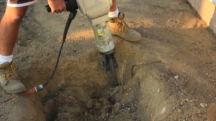 close up of a jackhammer digging a hole.