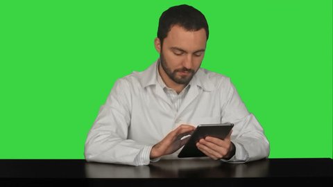 Male doctor with digital tablet at medical office on a Green Screen, Chroma Key