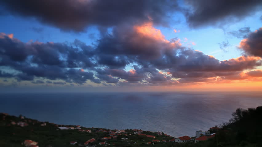 Sunrise above coastal city with moving cloud 