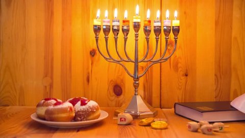 Menorah with burning candles and donuts, Hanukkah Holidays