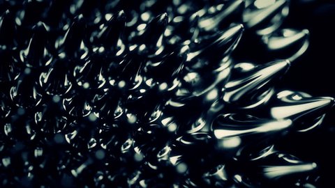 Black liquid surface. Abstract background. Ferrofluid close-up 4K UHD.
