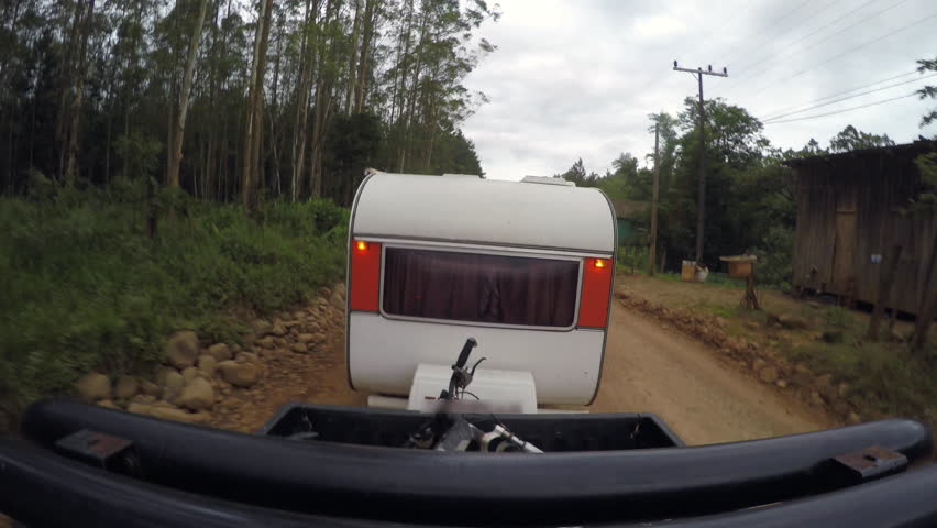 Trailer caravan car travelling on dirt road in Brazil