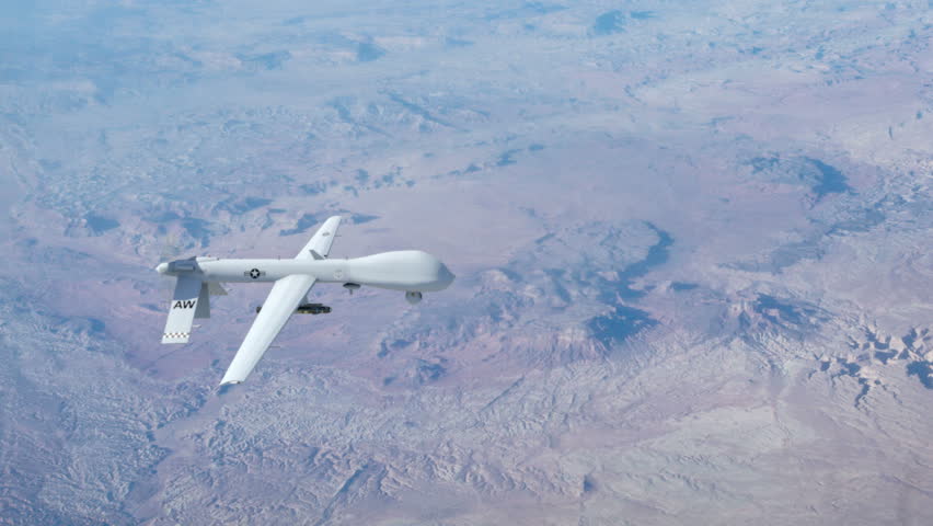 A Predator drone flying at high above the clouds conducting surveillance. 