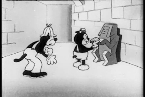 CIRCA 1930s - A 1930s animated cat plays a piano duet with a skeleton in an Egyptian tomb.