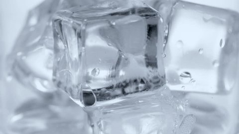 Pouring soda water with ice and bubbles in the glass. close-up 4K UHD 2160p.
