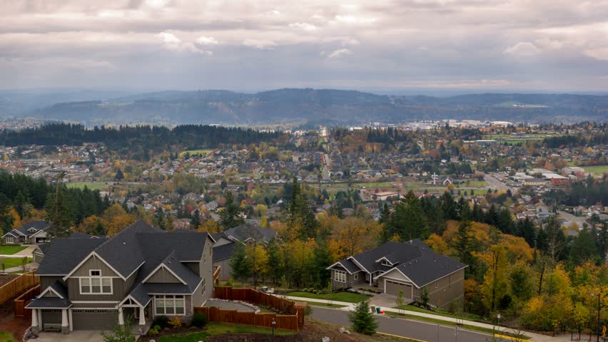 Time Lapse movie of thick moving clouds and sun rays over city of Happy Valley Oregon residential suburbs homes landscape in colorful fall autumn season uhd 4k 4096x2304