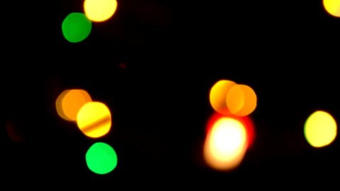 Bokeh - Blurred Christmas tree lights. Xmas time and New Year decoration. Blinking defocus colourful light. Night out of focus. Abstract blurry background. Seamless loop. Celebrate, glitter 1920x1080