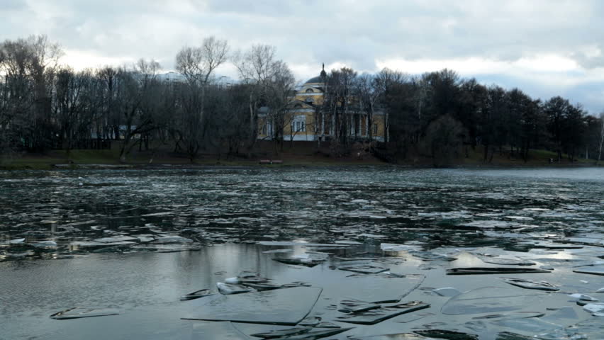 Pond with ice formed in December, and the old building HD