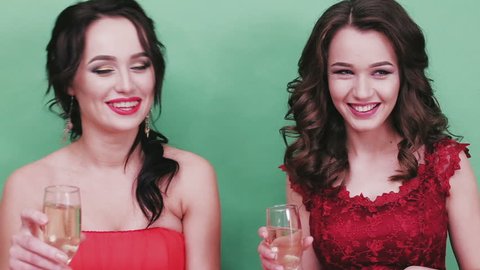 Two girls in a red drink champagne