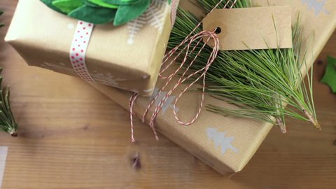 Wrapping Christmas gifts in recycled brown paper with vintage style at home.