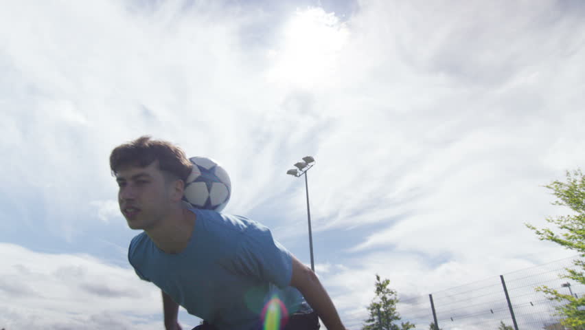 4K Portrait of young sports player showing off his ball control skills. Shot on RED Epic.