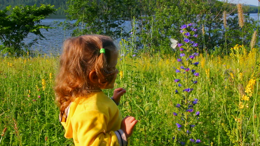 little girl and butterfly on flower