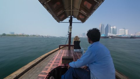 DUBAI, UAE - SEPTEMBER 14: Excursion on traditional Abra boat at the creek in Dubai, UAE timelapse hyperlapse The cheapest transport. View brom back