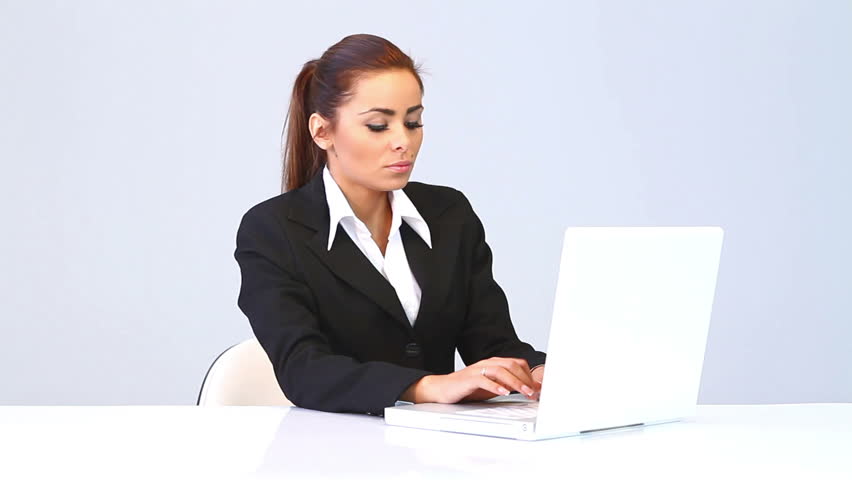 Young business woman writing on laptop computer