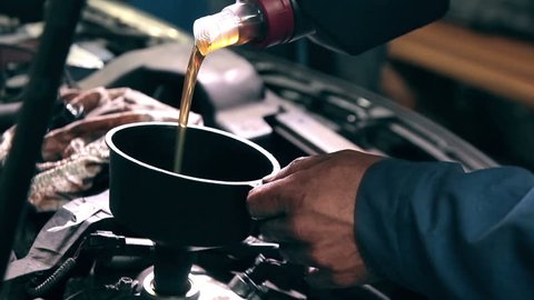 Process of changing engine oil in car service station