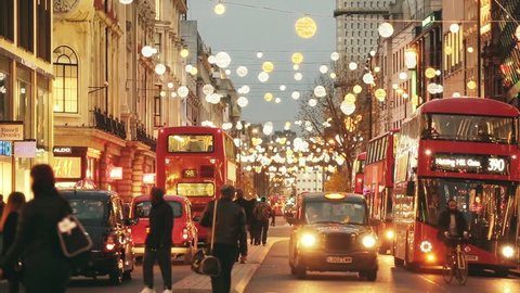 LONDON, UK - NOVEMBER 23, 2015: Oxford street with Christmas lights and traffic. It is one of the busiest street of the capital city of England, and during Christmas time it becomes magic and fairy.