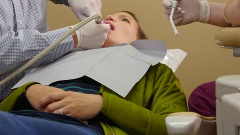 A woman has her teeth checked in a dentist office