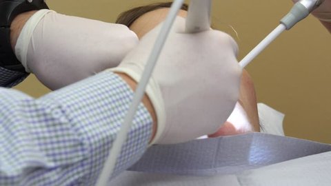 A woman has her teeth checked in a dentist office