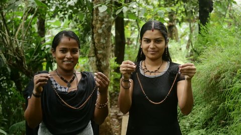 Indian Sisters Holding Handmade Clay Jewellery 