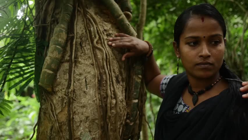 Cute Indian Girl Leaning On Tree With Lianas