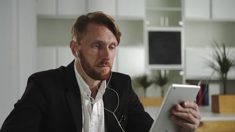 Businessman talking to a tablet. UHD 4Kvideo