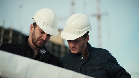 Engineer and client looking on project on the construction site