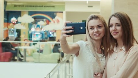 girlfriends do the selfie in entertainment shopping center