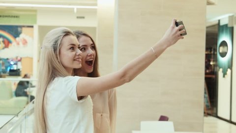 girlfriends do the selfie in entertainment shopping center