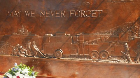 NEW YORK, NEW YORK, USA – SEPTEMBER 15, 2015: panning shot of a memorial to ny fire fighters killed on sept 11 in new york city