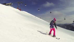 Beautiful full HD action video footage of a young girl snowboarding in the Italian alps