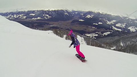 Beautiful full HD action video footage of a young girl snowboarding 