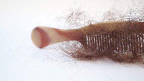 Bunch of hair on the comb. Hair loss concept