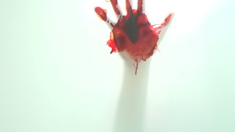 Bloody hand on glass window