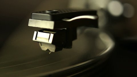 Close up HD movie of a record player playing a vinyl black record.