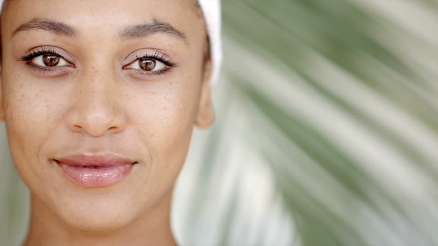 Face of young adult woman with clean fresh skin slow motion