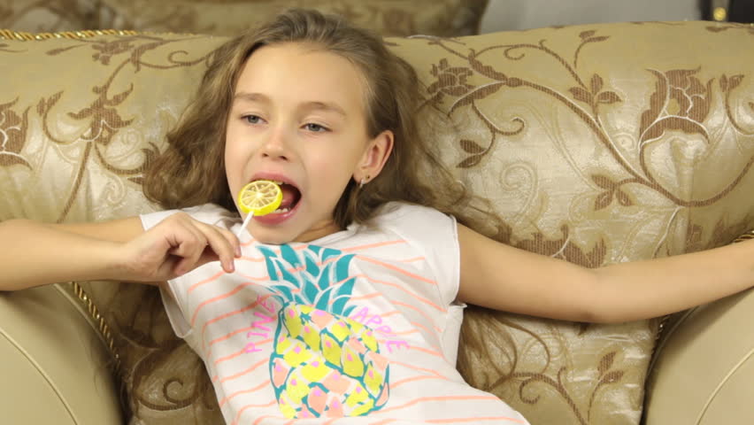 Girl Licking Candy On a Stock Footage Video (100% Royalty-free