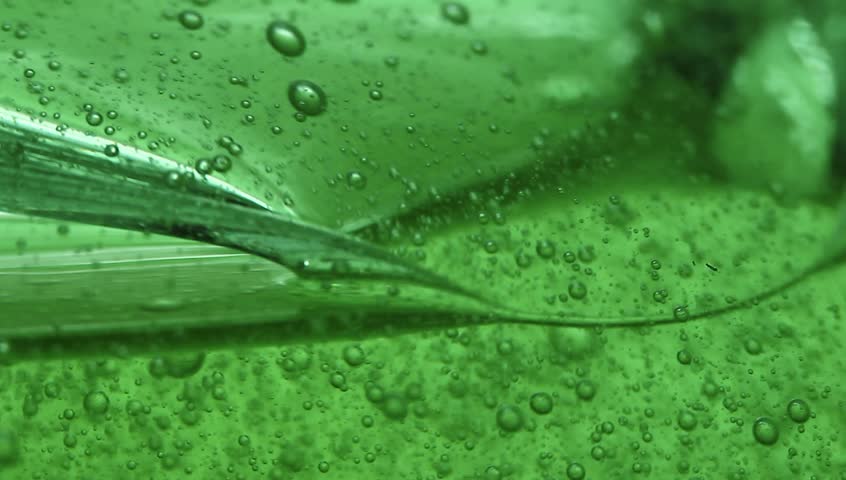 Extreme macro of green gel and intensive bubbles inside  it. Royalty-Free Stock Footage #13253432
