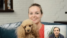 Young woman with dog have a chat video.