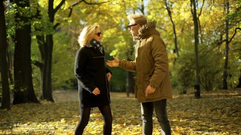 Couple having an argument in the autumnal park
