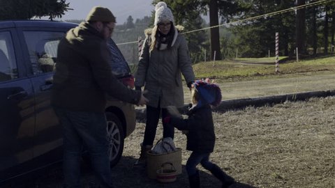 Mother And Father Put Christmas Tree On Top Of Car, Their Little Boy Helps, Gives Father Rope 