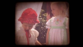 Old home movie of kids playing in their back yard with a vintage 8mm film look. Shots are recent, but very authentic looking. Includes projector audio.