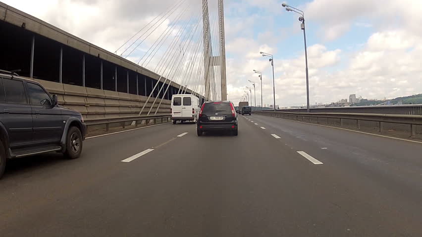 Kiev, Ukraine 30.07.2015. Suspended road bridge. Cars drive on the bridge. | Shutterstock HD Video #13292627