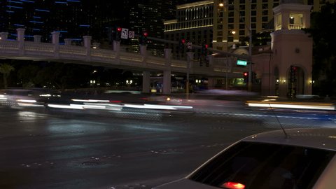 4K Las Vegas Strip Time Lapse: The Fountains at Bellagio dance in the background as the colored lights of traffic and taxi displays bring tourists and visitors to their hotel or casino destination