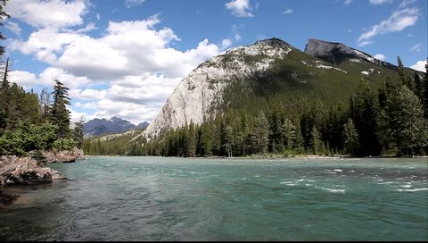 Bow river with a rapid current in a valley between mountains in Banff National Park (Alberta, Canada) 