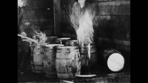 CIRCA 1930s - Federal agents destroy barrels of alcohol during Prohibition.